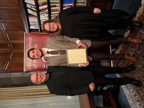 Sarnoff Fellow Frank Medina holds Gold Humanist aware plaque and stands with parents